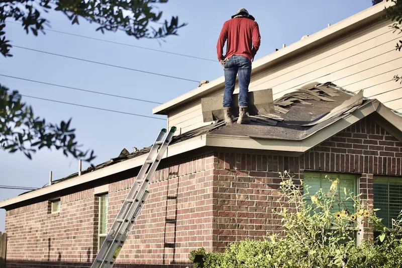 Professional roofer working on a residential roof in College Park